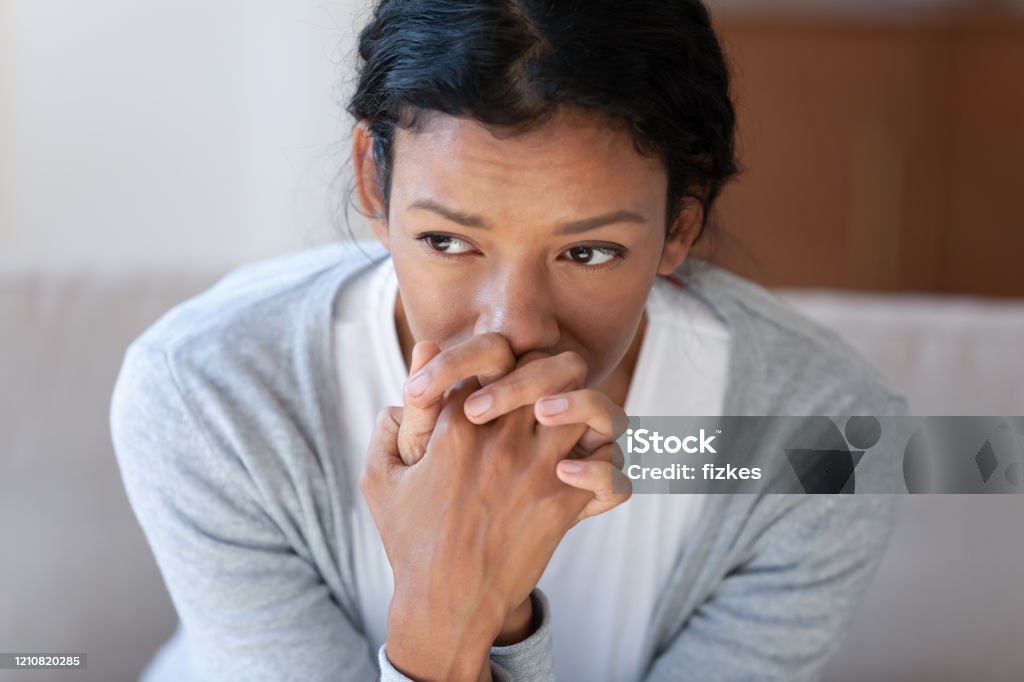 Pensive african American woman look in distance thinking Pensive African American young woman look in distance thinking pondering, thoughtful biracial millennial female lost in thoughts, suffer from depression or miscarriage, psychological help concept Anxiety Stock Photo