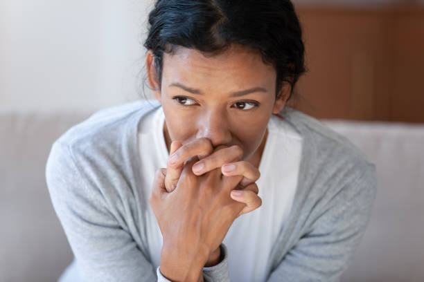 Pensive african American woman look in distance thinking Pensive African American young woman look in distance thinking pondering, thoughtful biracial millennial female lost in thoughts, suffer from depression or miscarriage, psychological help concept pessimism photos stock pictures, royalty-free photos & images