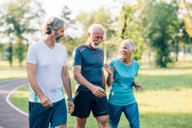 istock Smiling senior athletes jogging in the park 1210820343