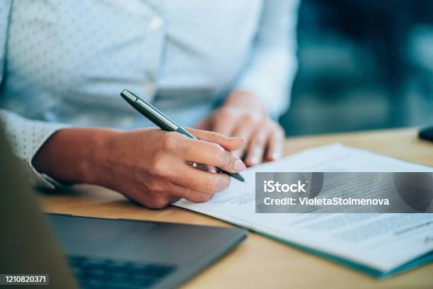 Businesswoman Checking Agreement Before Signing Stock Photo - Download Image Now - Contract, Document, Signing