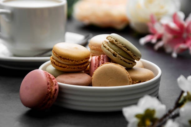 istock Cup of coffee and macaroons on colorful black background. top view. 1210820478
