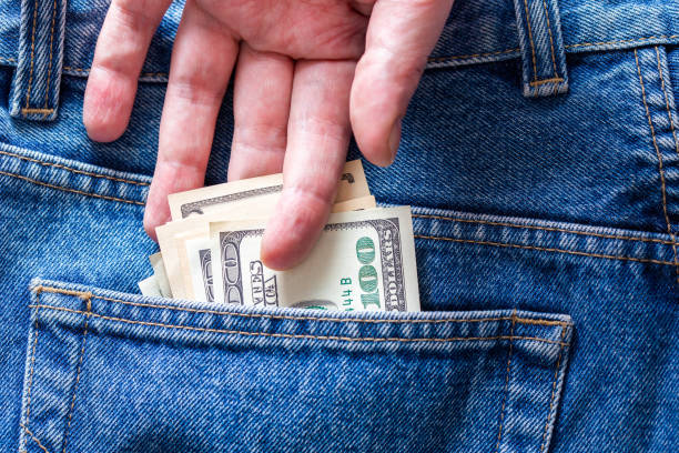 istock a hand taking hundred dollar banknote from rear jeans pocket 1210820893