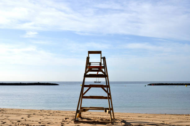 istock Empty life guard rescue chair on the beach. 1210821601