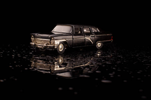 istock Luxury black USSR car die-cast model on the black reflective background 1210821619