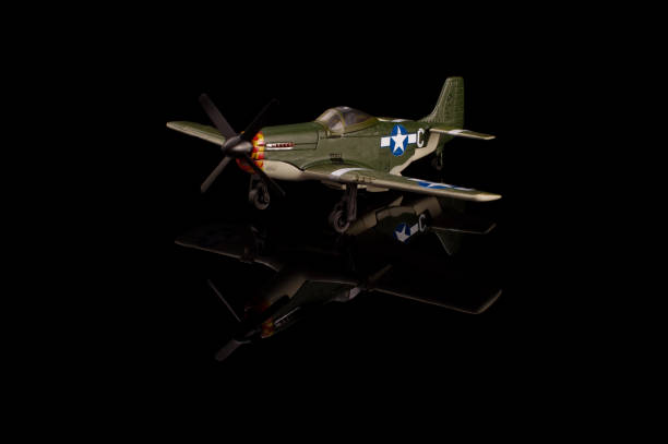istock WWII die cast model plane isolated on the black background 1210821630