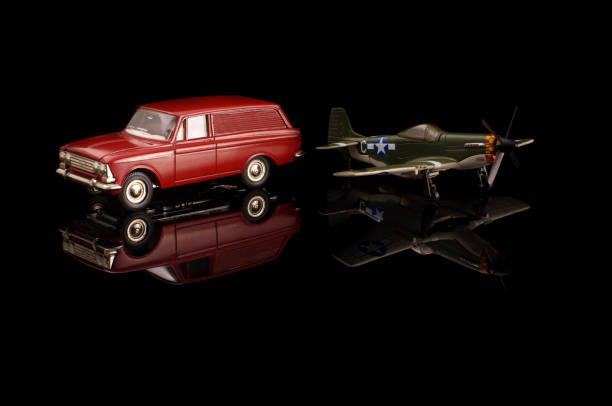 istock Die cast model car and model plane on the black reflective surface 1210821639