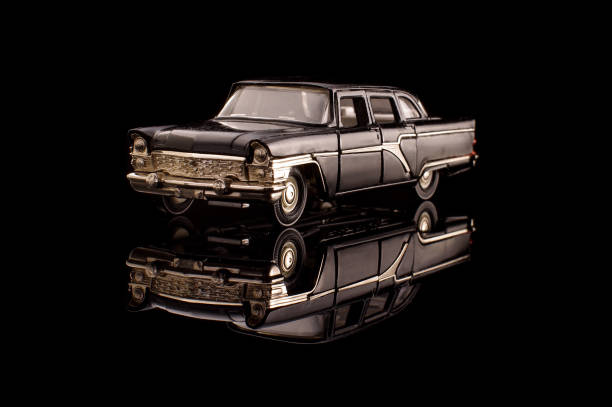 istock Luxury black USSR car die-cast model on the black reflective background 1210821782