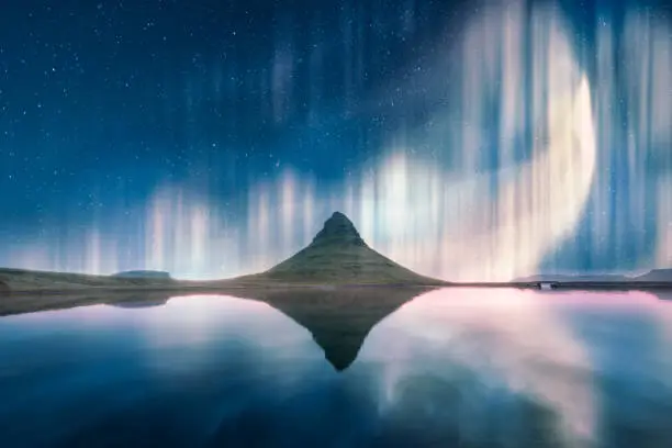 Photo of Green aurora light behind Kirkjufell mountain