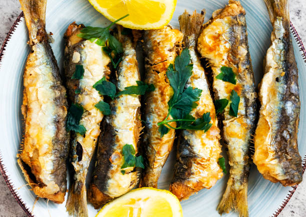 istock fried sardines on the plate decorated with lemon and parsley 1210824477