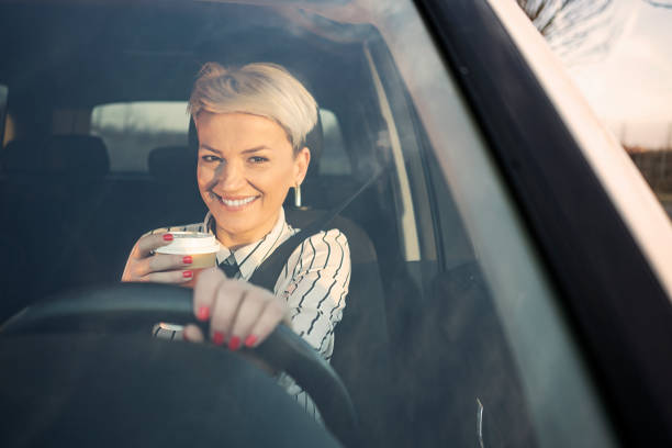 istock Smiling woman in a car 1210824641
