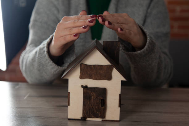 istock woman hand key with house model 1210824740