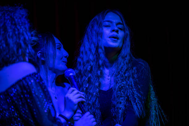 istock Three young girls performing karaoke 1210824895