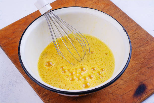 istock Beaten egg yolks in a bowl with whisk 1210825697