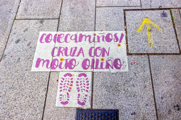 Santiago de Compostela, Spain - June 09, 2017: Itinerary marking of the Colecaminos project with the yellow arrow - waymarking on the Way of St. James, Camino de Santiago towards Finisterre