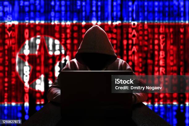 Cyber Threat From North Korea North Korean Hacker At The Computer On A Background Of Binary Code The Colors Of The Flag Of The Dprk Ddos Attack Stock Photo - Download Image Now