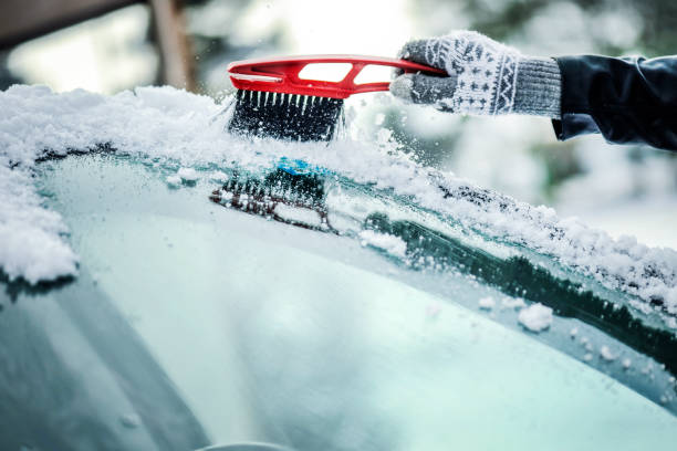 istock Cleaning snow from car window. Removing snow from windshield 1210833326