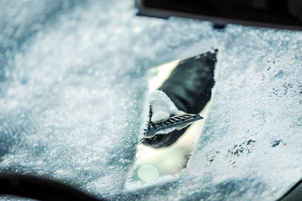 istock Cleaning snow from car window. Removing snow from windshield 1210833345