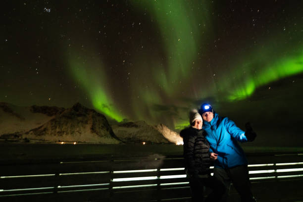 istock Couple with Aurora Borealis in background 1210833704