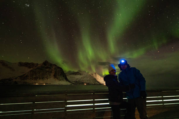 istock Couple with Aurora Borealis in background 1210834766