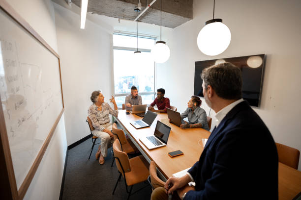 istock Business people watching a presentation at meeting room 1210834988