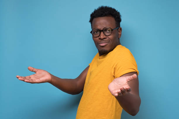 istock Unhappy man in glasses making arms out asking what is the problem who cares 1210835368
