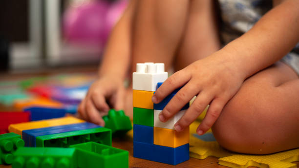 istock A child sitting on the floor plays with a children colorful constructor 1210837367