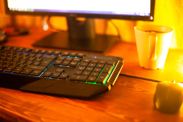 istock comfortable workplace of the programmer. computer keyboard in the warm rays of evening light lamp 1210837370
