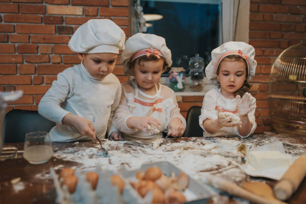 istock Family kids in white chef uniform baking bread. 1210837649
