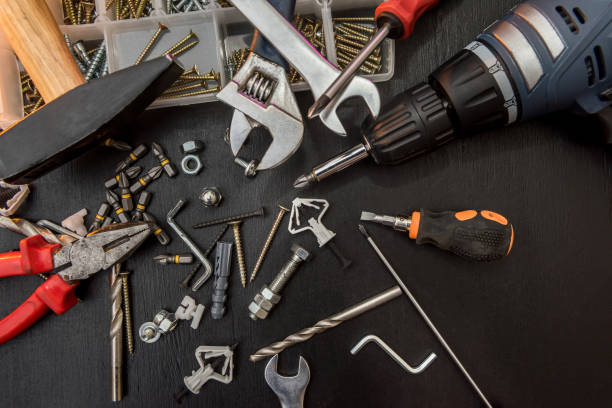 istock set of different tools with drill bits, screws, screwdriver bits and hexagon wrench for repair on black desk 1210839228
