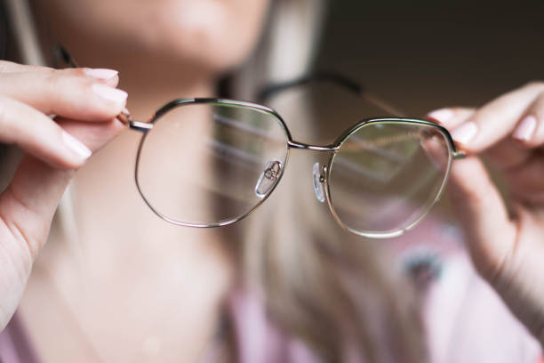 istock Woman holding glasses in hands 1210842450