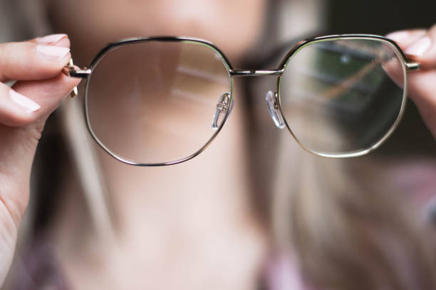 istock Woman holding glasses in hands 1210842464
