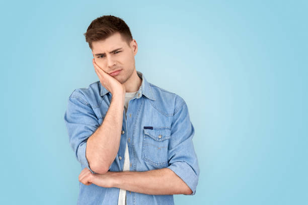 istock Young adult man making bored face looking at camera 1210842929