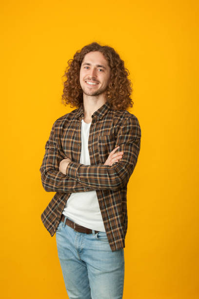 istock studio portrait of a young man with a beard on a yellow background 1210844862