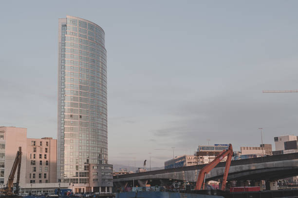Belfast, Northern Ireland, United Kingdom - February 7, 2020: M3 motorway bridge crossing the River Lagan towards Belfast city centre, towards the mixed use high rise, the Obel Tower (2010, to designs of Broadway Malyan Architects).