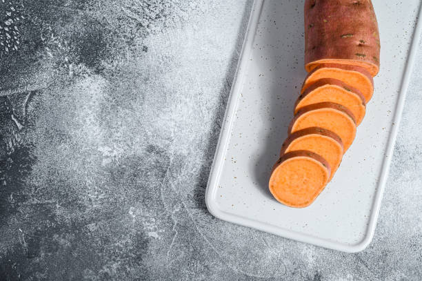 istock Raw yam, organic batatas. The farm vegetables. Gray background. Space for text 1210847351