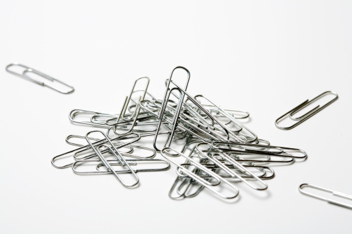 A pile of paperclips on a white background.