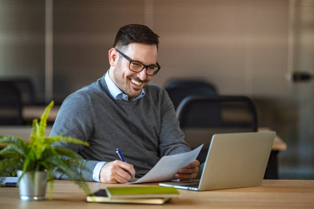 istock Young businessman using laptop at his office desk. 1210848149