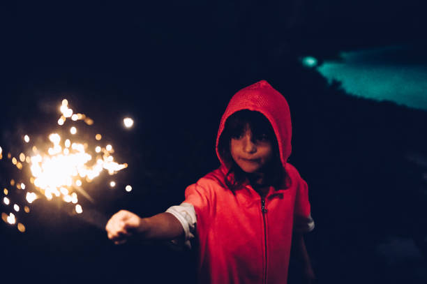 istock Child holds a sparkler firework at night in the dark 1210849242