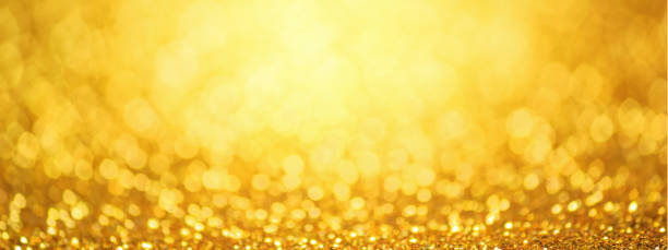 istock Golden glittering background, horizontal banner, panorama. Sparkle glitter texture with the bokeh and the lights, shiny metal gold foil 1210849291