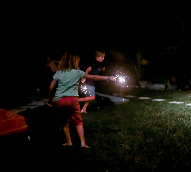 istock Child holds a sparkler firework at night in the dark 1210850162