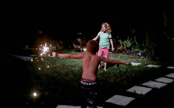 istock Child holds a sparkler firework at night in the dark 1210850172