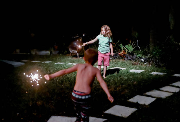 istock Child holds a sparkler firework at night in the dark 1210850193