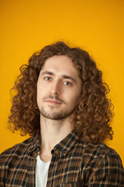istock studio portrait of a young man with a beard on a yellow background 1210850210