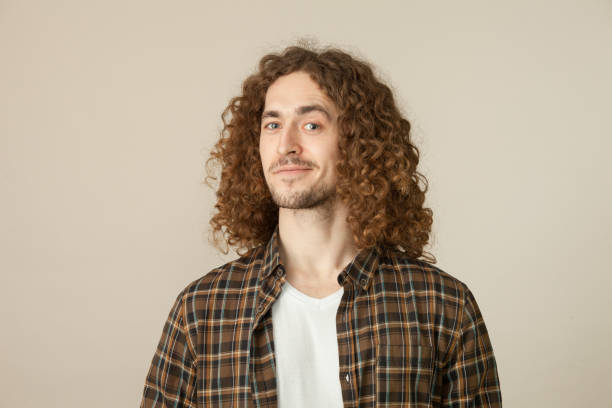 istock studio portrait of a young man with a beard on a beige background 1210850212