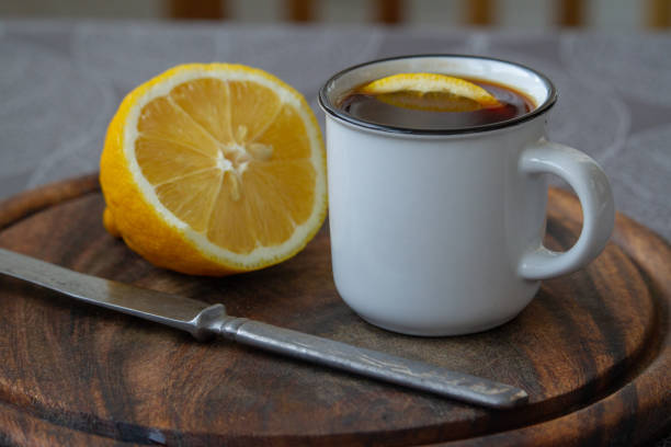 istock A cup of black coffee with a slice of lemon on a grey tablecloth, selective focus 1210852654