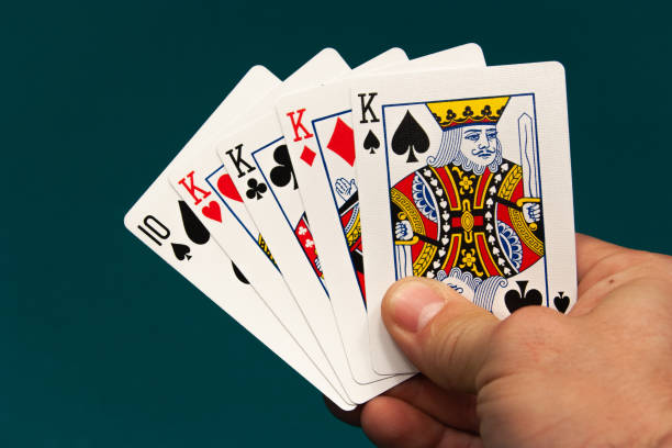 five different play cards in a hand stock photo