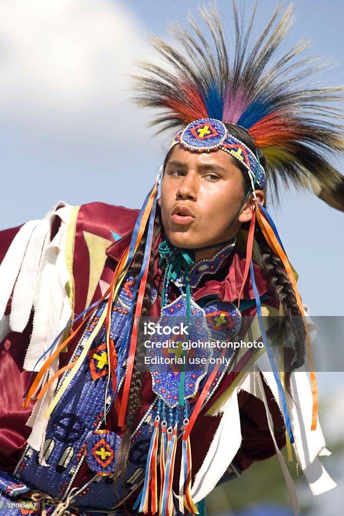 Native American dance. Post Falls, Idaho, USA - July 25, 2009: A native American young man takes part in the Julyammsh Powwow in Post Falls, Idaho. Regional tribes gather for this traditional native American dance competition. Indigenous Peoples of the Americas Stock Photo