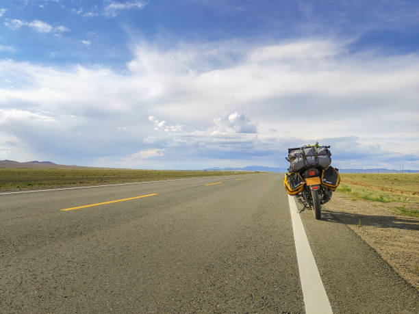 istock Motorcycle with travel baggage parked by the roadside 1210856673