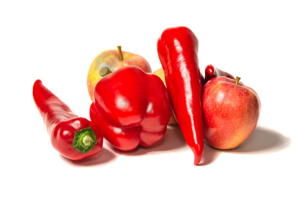 istock Red apple and pepper isolated on a white background 1210857324