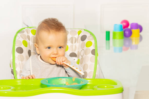 istock Toddler boy with thoughtful look and baby spoon 1210862809